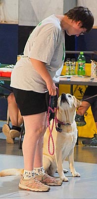 4-H'er and dog looking up at her.